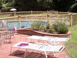 Brick patio and retaining wall by pool