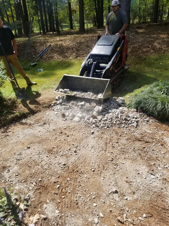 Skid steer grading gravel on job site